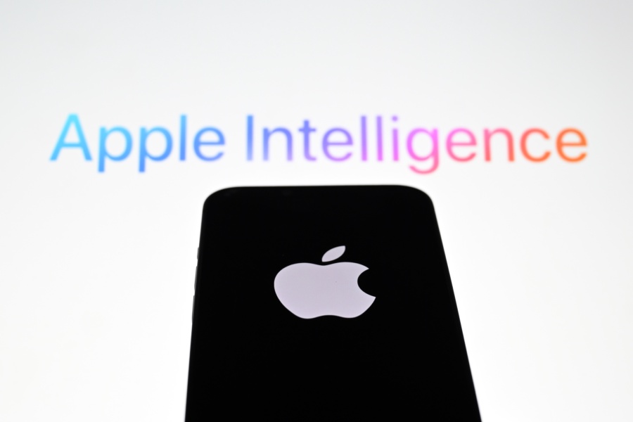 ANKARA, TURKIYE - JUNE 10: In this photo illustration, the 'Apple' logo is displayed on a mobile phone screen in front of a computer screen displaying Apple Intelligence logo in Ankara, Turkiye on June 10, 2024. (Photo by Hakan Nural/Anadolu via Getty Images)