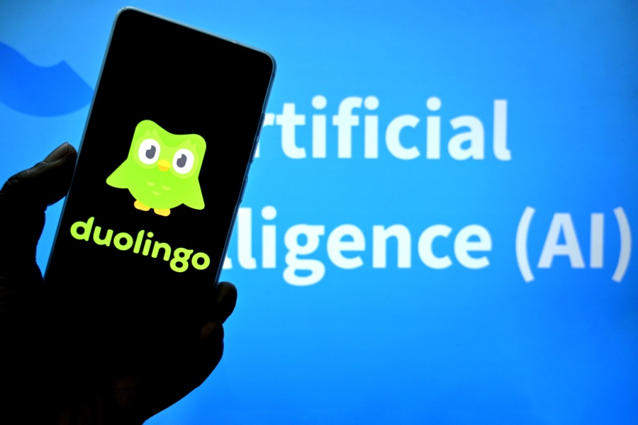 INDIA - 2025/03/05: In this photo illustration, a Duolingo logo is seen displayed on a smartphone with an Artificial Intelligence writing in the background. (Photo Illustration by Avishek Das/SOPA Images/LightRocket via Getty Images)