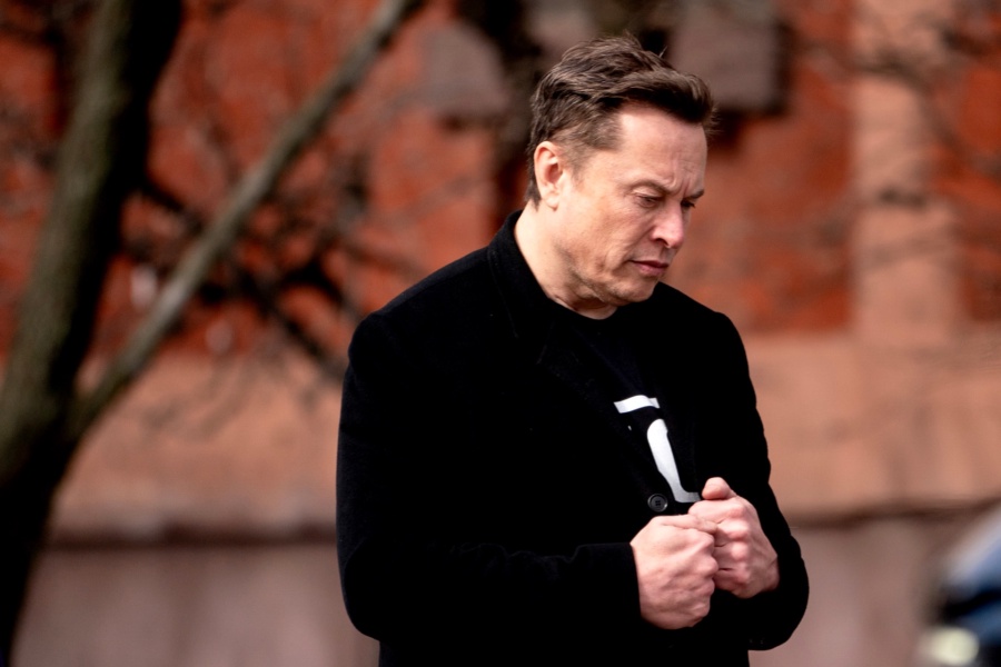 Elon Musk, chief executive officer of Tesla Inc., walks to the Eisenhower Executive Office Building (EEOB) near the White House in Washington, DC, US, on Thursday, Feb. 13, 2025. US President Donald Trump has gravitated toward the reciprocal tariff plan as a key part of his push to raise US levies overall, stating it would apply to nations who generally have a higher average tariff rate than the US, which would raise its own tariff to match them. Photographer: Stefani Reynolds/Bloomberg