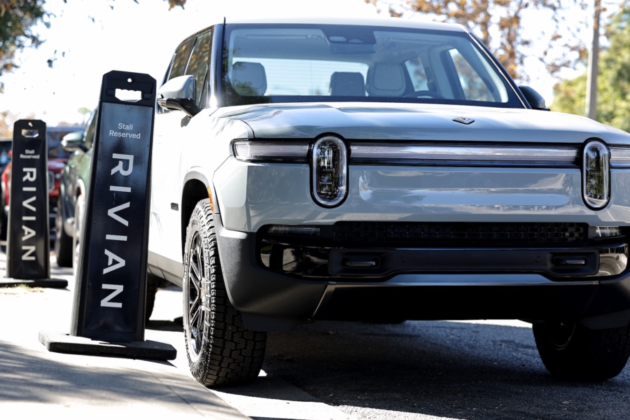 Rivian electric vehicles are parked at the Rivian Venice Hub on November 13, 2024 in Venice, California. The California-based electric vehicle manufacturer Rivian's joint venture with German automaker Volkswagen is being expanded to $5.8 billion.