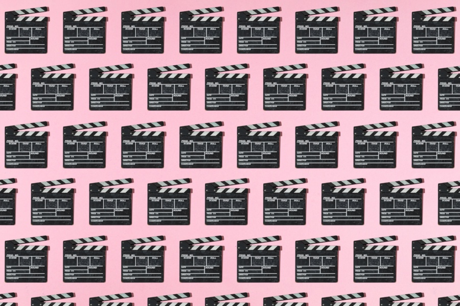 Wooden old movie clapperboard pattern with hard shadow on pink background. Concept of film industry, cinema, entertainment, and Hollywood.