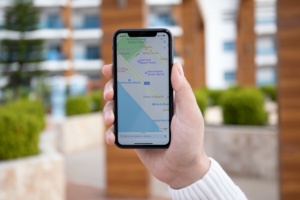 Alanya, Turkey - March 31, 2020: Man hand holding iPhone 11 with Apple map on the screen. iPhone was created and developed by the Apple inc.