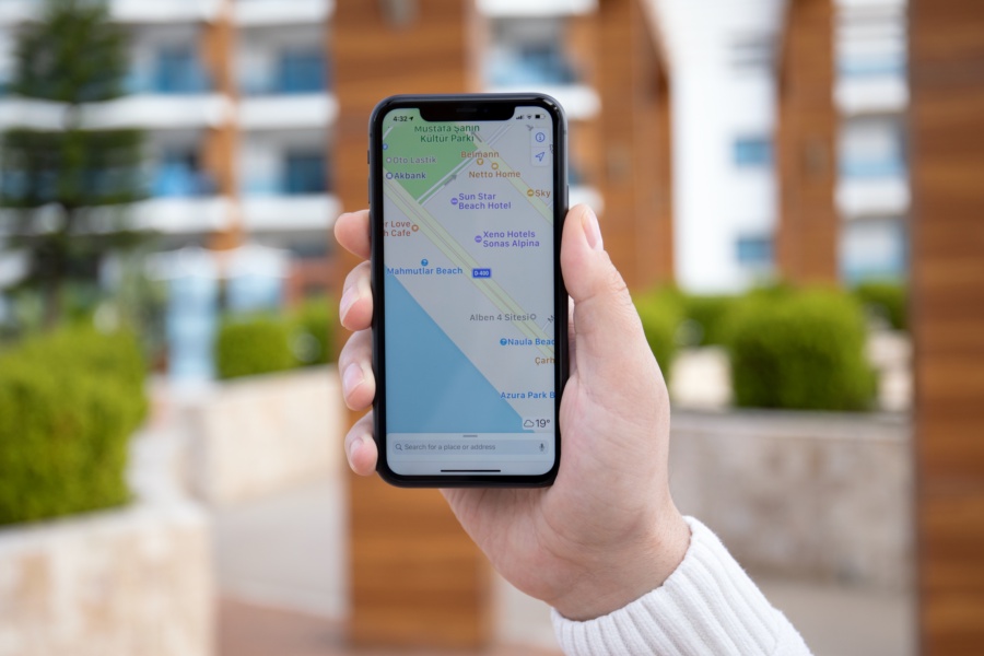 Alanya, Turkey - March 31, 2020: Man hand holding iPhone 11 with Apple map on the screen. iPhone was created and developed by the Apple inc.
