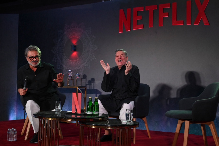 Bollywood director, screenwriter and music composer Sanjay Leela Bhansali (L) along with American businessman and co-chief executive officer of Netflix, Ted Sarandos (R) gesture during an event in Mumbai on February 18, 2023. (Photo by SUJIT JAISWAL / AFP) (Photo by SUJIT JAISWAL/AFP via Getty Images)