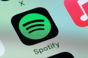 Spotify, Apple Music on smart phone screen.