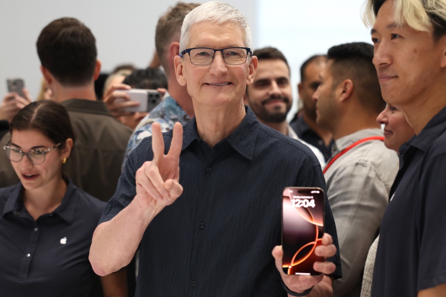 CUPERTINO, CALIFORNIA - SEPTEMBER 09: Apple CEO Tim Cook inspects the new iPhone 16 during an Apple special event at Apple headquarters on September 09, 2024 in Cupertino, California. Apple held an event to showcase the new iPhone 16, Airpods and Apple Watch models. (Photo by Justin Sullivan/Getty Images)