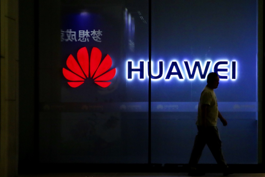 BEIJING, CHINA - MAY 30: A pedestrian walks past a Huawei store on May 30, 2019 in Beijing, China. (Photo by VCG/VCG via Getty Images)