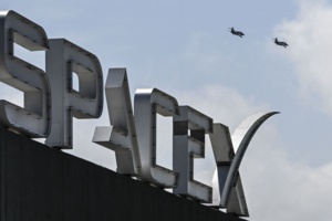 US billionaire businessman and pilot Jared Isaacman flies in formation aboard a fighter jet over the SpaceX sign, close to the Starship spacecraft, before his third test flight from Starbase in Boca Chica, Texas, on March 13, 2024. Elon Musk's SpaceX announced it was eyeing March 14 as the earliest date for the next test launch of its giant Starship rocket, with which it hopes to one day colonize Mars. Two previous attempts have ended in spectacular explosions, though the company has adopted a rapid trial-and-error approach in order to accelerate development. (Photo by CHANDAN KHANNA/AFP via Getty Images)