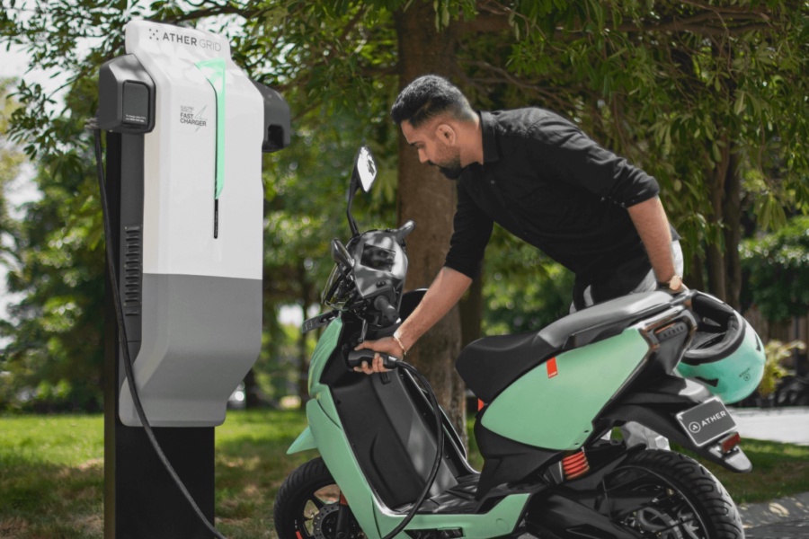 Man charging electric motor scooter