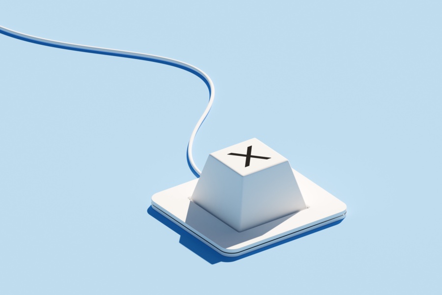 A keyboard with a single key featuring an "X" icon is set against a blue background. The "X" symbol typically represents rejection, cancellation, or incorrect choices, emphasizing decision-making processes. The minimalist design of the keyboard, combined with the vibrant blue backdrop, creates a modern look that highlights themes of selection and error management.