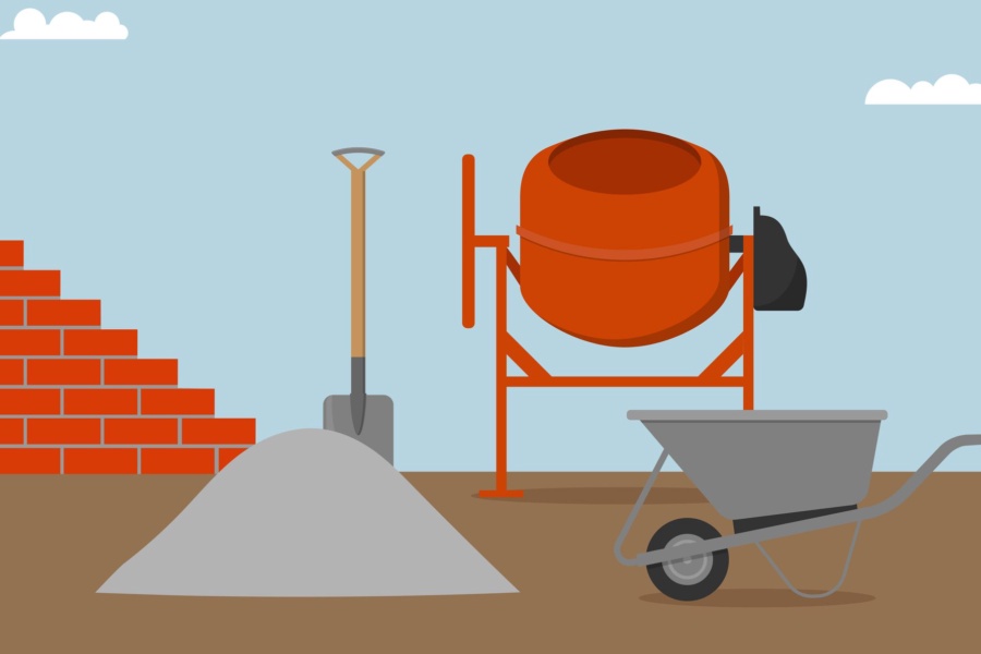 Brick wall, concrete mixer, wheelbarrow, bucket and spade.