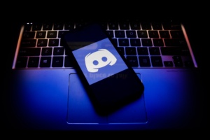 Discord logo displayed on a phone screen and a keyboard. (Photo Illustration by Jakub Porzycki/NurPhoto via Getty Images)