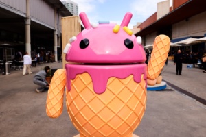 The Google Android logo and mascot, known as Bugdroid by the community, is being displayed as a statue resembling a strawberry ice-cream cone on Android Avenue at the Mobile World Congress 2024 in Barcelona, Spain, on March 25, 2024. (Image: Joan Cros/NurPhoto/Getty Images)